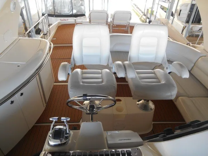  Yacht Photos Pics 2004 Meridian 540 Pilothouse interior with white leather seating and wooden flooring.