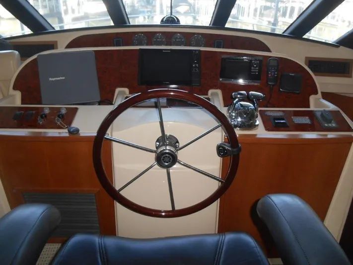  Yacht Photos Pics 2004 Meridian 540 Pilothouse helm with steering wheel and navigation equipment.