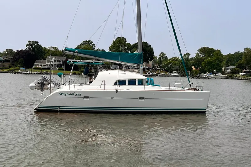 Wayward Sun Yacht Photos Pics 2000 Lagoon 380 catamaran "Wayward Sun" anchored in a scenic harbor.