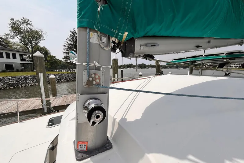 Wayward Sun Yacht Photos Pics Lagoon 380 catamaran mast and rigging, docked by a serene waterfront, year 2000 model.