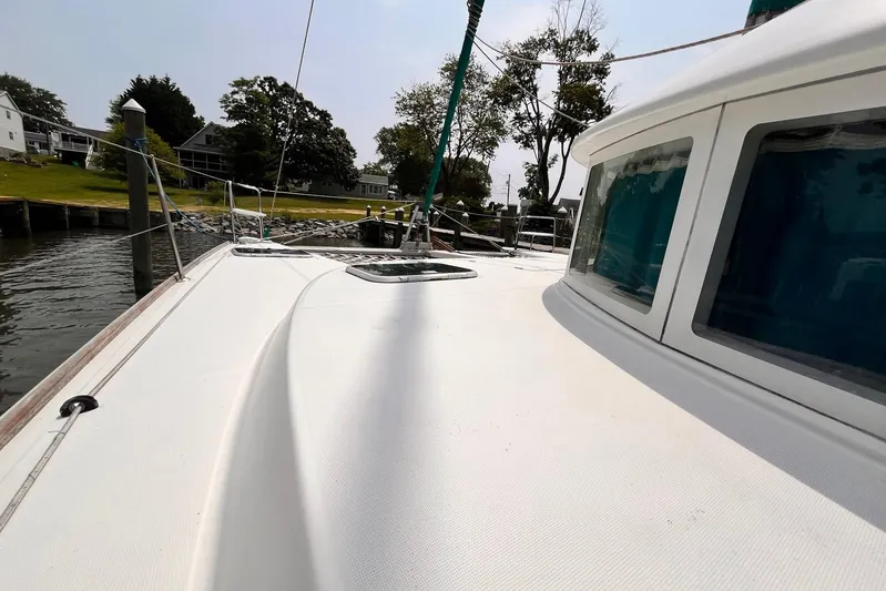 Wayward Sun Yacht Photos Pics Lagoon 380 catamaran deck view, docked near waterfront homes, 2000 model.