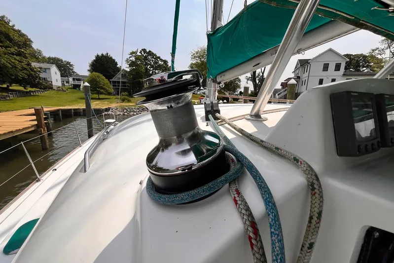 Wayward Sun Yacht Photos Pics Lagoon 380 sailboat deck with winch and ropes, docked near waterfront homes.