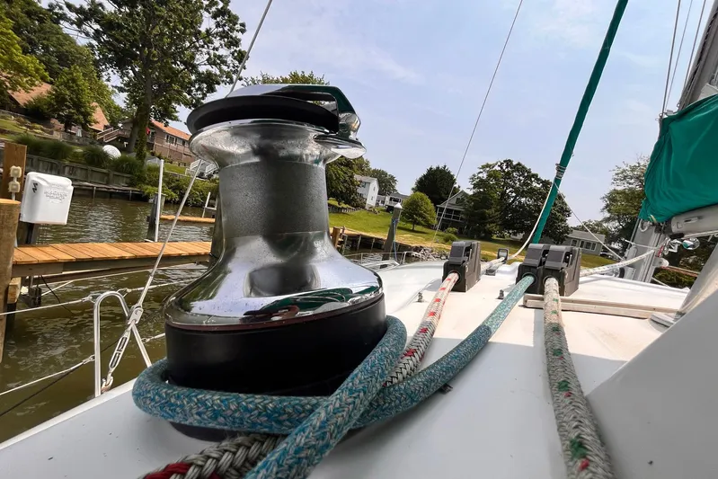 Wayward Sun Yacht Photos Pics Deck view of a 2000 Lagoon 380 catamaran with ropes and winch near a dock.