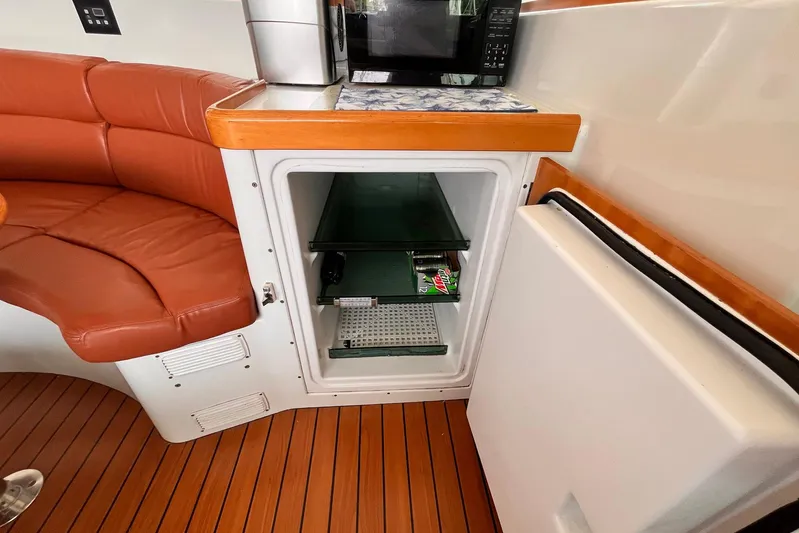 Wayward Sun Yacht Photos Pics Interior of a 2000 Lagoon 380 yacht with open fridge and leather seating.