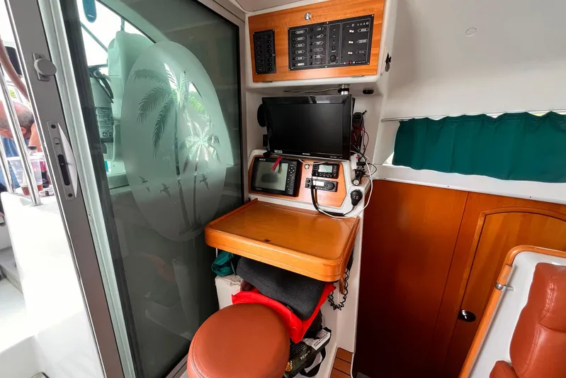 Wayward Sun Yacht Photos Pics Interior of 2000 Lagoon 380 catamaran with navigation equipment and etched glass door.