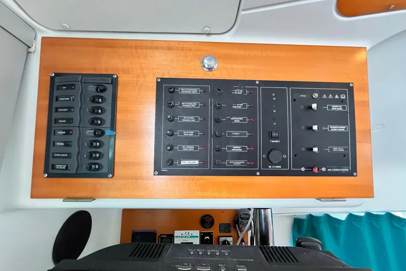 Wayward Sun Yacht Photos Pics Electrical control panel of a 2000 Lagoon 380 catamaran with various switches and indicators.