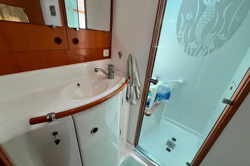 Wayward Sun Yacht Photos Pics Bathroom interior of 2000 Lagoon 380 catamaran with sink and shower area.