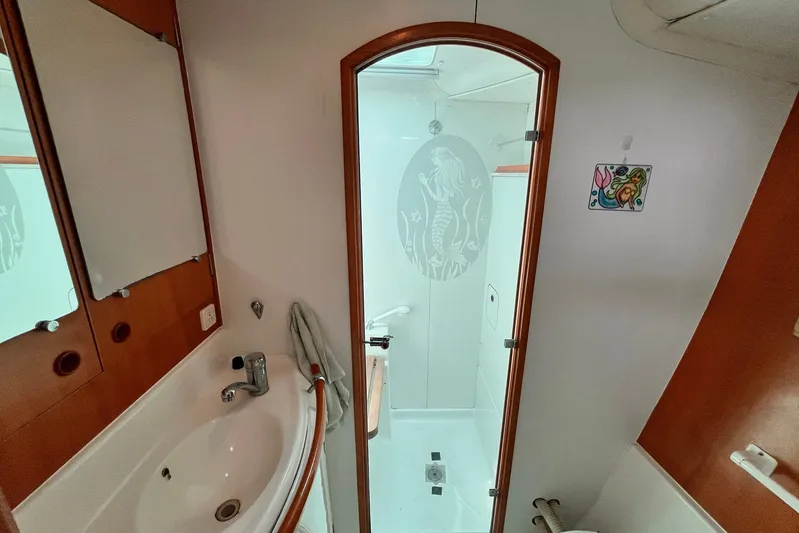 Wayward Sun Yacht Photos Pics Bathroom interior of 2000 Lagoon 380 catamaran with shower and sink.