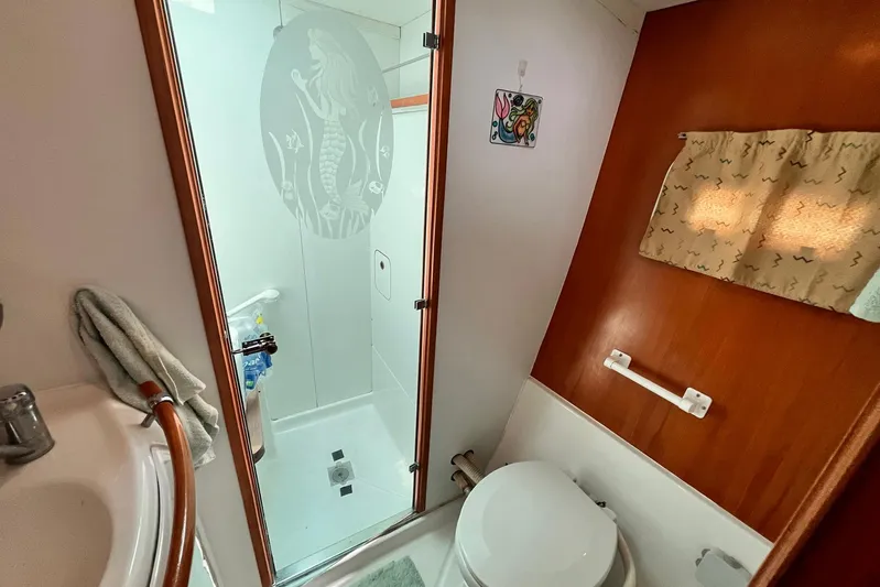 Wayward Sun Yacht Photos Pics Bathroom interior of 2000 Lagoon 380 catamaran with shower and toilet.