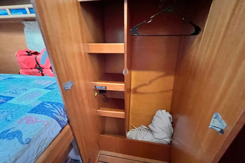 Wayward Sun Yacht Photos Pics Wooden closet interior on Lagoon 380 catamaran, 2000 model, with shelves and hangers.