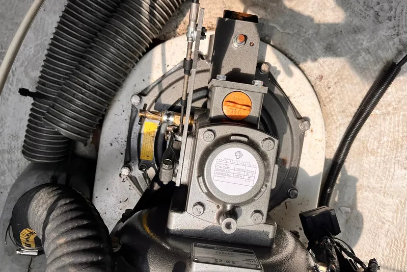 Wayward Sun Yacht Photos Pics Engine compartment of a 2000 Lagoon 380 catamaran, featuring mechanical components and hoses.