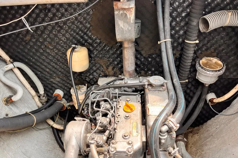 Wayward Sun Yacht Photos Pics Engine compartment of a 2000 Lagoon 380 catamaran with visible hoses and components.