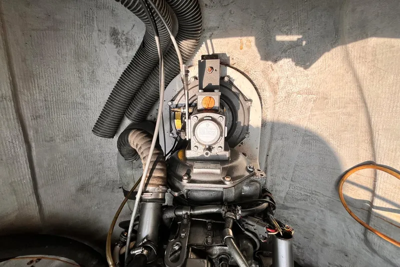 Wayward Sun Yacht Photos Pics Engine compartment of a 2000 Lagoon 380 catamaran, showcasing mechanical components and hoses.