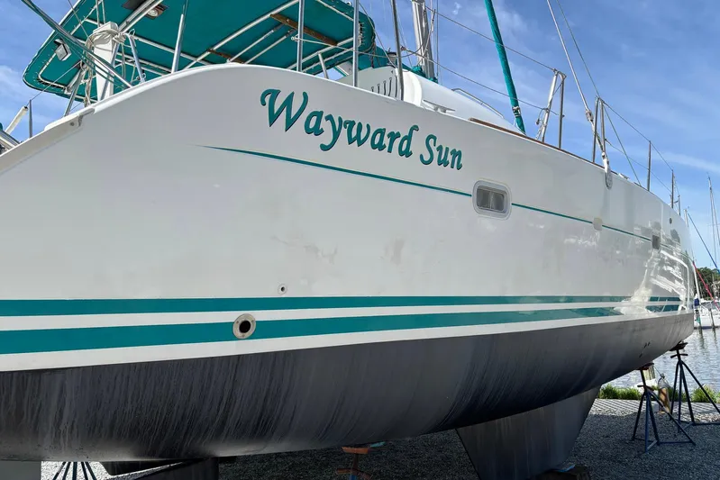 Wayward Sun Yacht Photos Pics Lagoon 380 catamaran, 2000 model, named "Wayward Sun" on a boatyard stand.