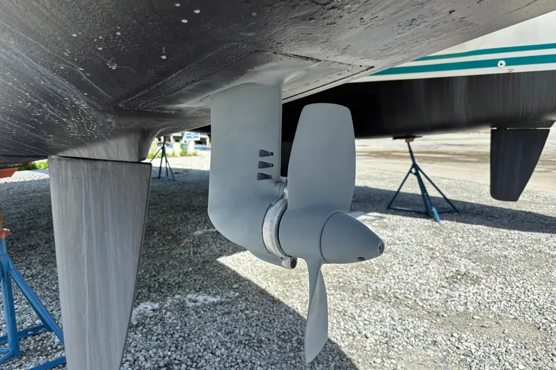 Wayward Sun Yacht Photos Pics Propeller of a 2000 Lagoon 380 catamaran on dry dock, showcasing hull and support stands.