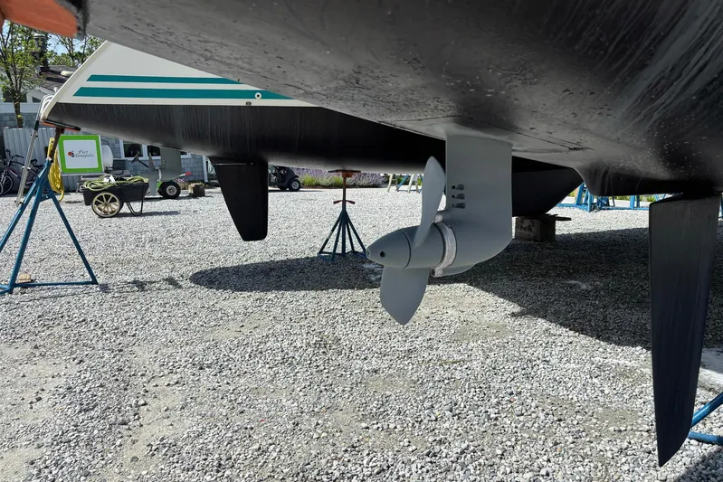 Wayward Sun Yacht Photos Pics Underneath view of a 2000 Lagoon 380 catamaran, showcasing its propeller and hull.