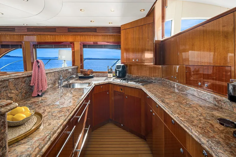 Bellissimo Yacht Photos Pics Luxurious kitchen interior of 2001 Hatteras 63 Cockpit Motor Yacht with ocean view.