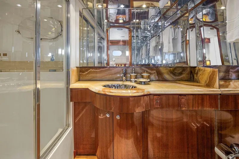 Bellissimo Yacht Photos Pics Luxurious bathroom in 2001 Hatteras 63 Cockpit Motor Yacht with elegant wood and marble finishes.