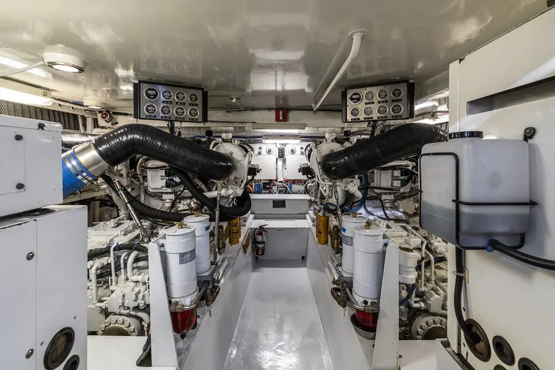 Bellissimo Yacht Photos Pics Engine room of 2001 Hatteras 63 Cockpit Motor Yacht, showcasing machinery and control panels.