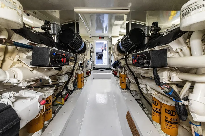 Bellissimo Yacht Photos Pics Engine room of 2001 Hatteras 63 Cockpit Motor Yacht with dual Caterpillar engines.