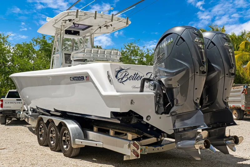  Yacht Photos Pics 2024 Contender 35 ST boat with dual Yamaha engines on a trailer, parked outdoors.