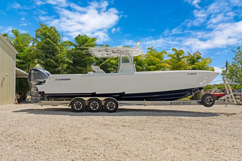  Yacht Photos Pics 2024 Contender 35 ST boat on trailer, parked outdoors under blue sky.