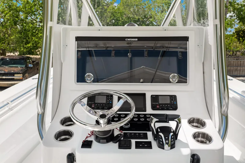  Yacht Photos Pics 2024 Contender 35 ST boat dashboard with steering wheel and control panel.