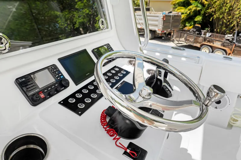  Yacht Photos Pics 2024 Contender 35 ST boat dashboard with steering wheel and electronic controls.