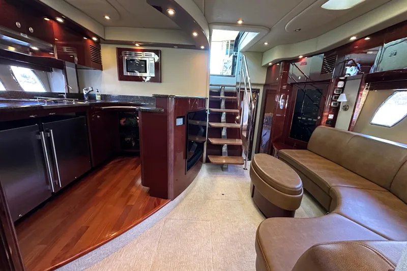 Ohana Yacht Photos Pics Luxurious interior of 2007 Sea Ray 60 Sundancer yacht with modern kitchen and seating area.