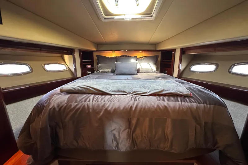 Ohana Yacht Photos Pics Luxurious bedroom interior of 2007 Sea Ray 60 Sundancer yacht with cozy bedding.