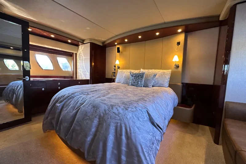 Ohana Yacht Photos Pics Luxurious bedroom interior of 2007 Sea Ray 60 Sundancer yacht with elegant bedding and lighting.