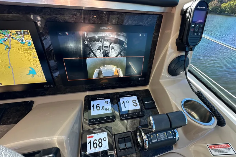 Ohana Yacht Photos Pics Control panel of a 2007 Sea Ray 60 Sundancer with navigation and monitoring screens.