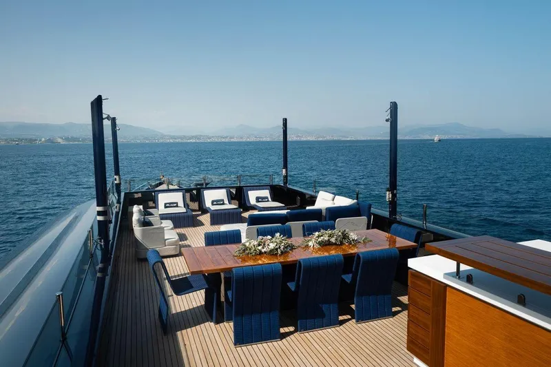 Blade II Yacht Photos Pics Luxurious yacht deck with elegant seating and dining area, MMGI BLADE II, 2009 model.