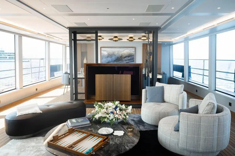 Blade II Yacht Photos Pics Luxurious yacht interior with modern seating, large windows, and elegant decor on MMGI BLADE II, 2009.