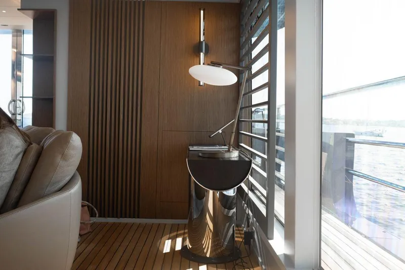 Blade II Yacht Photos Pics Luxurious yacht interior with modern decor, featuring sleek wood paneling and elegant lighting.