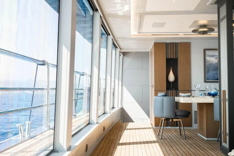 Blade II Yacht Photos Pics Luxurious yacht interior with ocean view, featuring elegant dining area and modern decor.