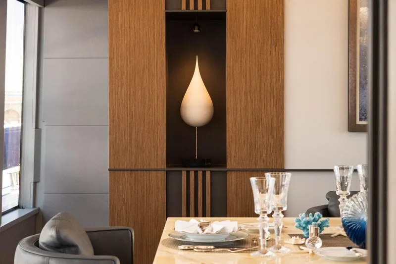 Blade II Yacht Photos Pics Elegant dining area with modern decor, featuring a unique teardrop-shaped light fixture.