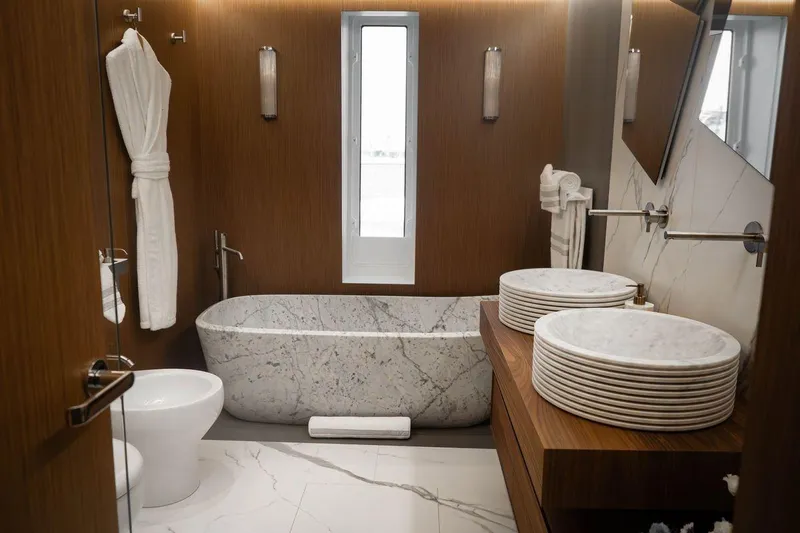 Blade II Yacht Photos Pics Luxurious yacht bathroom with marble bathtub, dual sinks, and wooden accents, MMGI BLADE II 2009.