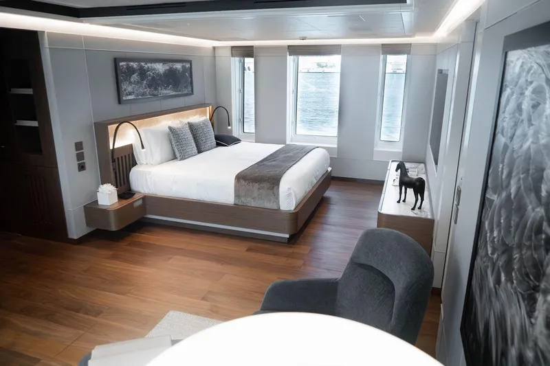 Blade II Yacht Photos Pics Luxurious yacht bedroom with modern decor, large windows, and elegant furnishings on MMGI BLADE II, 2009.