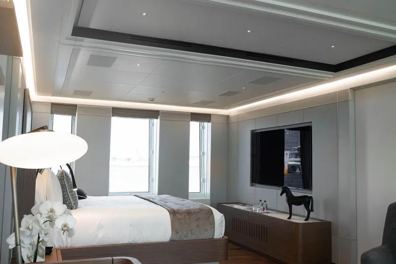 Blade II Yacht Photos Pics Luxurious yacht bedroom interior with modern decor, large windows, and sleek furnishings on MMGI BLADE II.