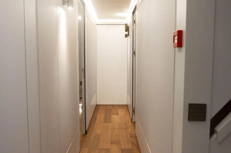 Blade II Yacht Photos Pics Narrow hallway with wooden flooring on MMGI BLADE II yacht, 2009 model.