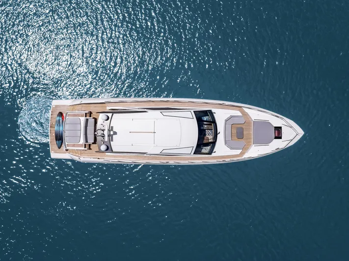 Bikinis Optional Yacht Photos Pics Aerial view of 2012 Cheoy Lee 76 Alpha yacht cruising on blue ocean waters.