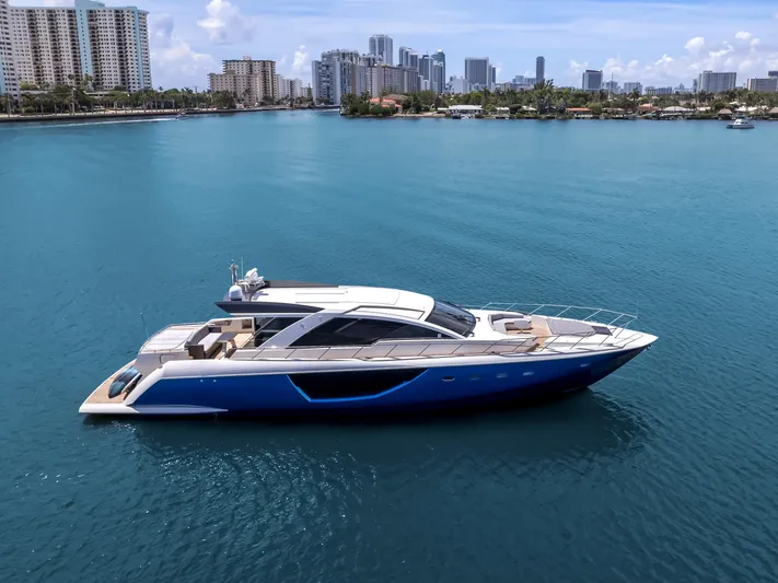 Bikinis Optional Yacht Photos Pics Luxury 2012 Cheoy Lee 76 Alpha yacht on calm blue water, city skyline background.
