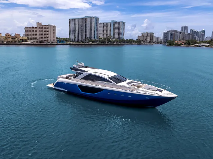 Bikinis Optional Yacht Photos Pics Luxurious 2012 Cheoy Lee 76 Alpha yacht cruising in a serene blue harbor.