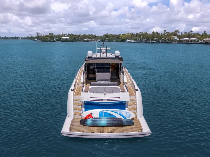 Bikinis Optional Yacht Photos Pics 2012 Cheoy Lee 76 Alpha yacht on calm water, rear view with water sports equipment.