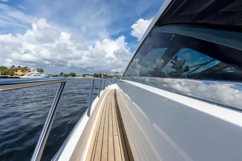 Bikinis Optional Yacht Photos Pics 2012 Cheoy Lee 76 Alpha yacht with sleek deck and scenic water view.