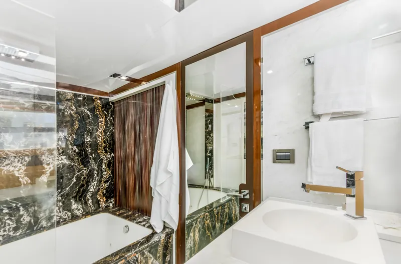 Bikinis Optional Yacht Photos Pics Luxurious bathroom in 2012 Cheoy Lee 76 Alpha yacht with marble accents and modern fixtures.