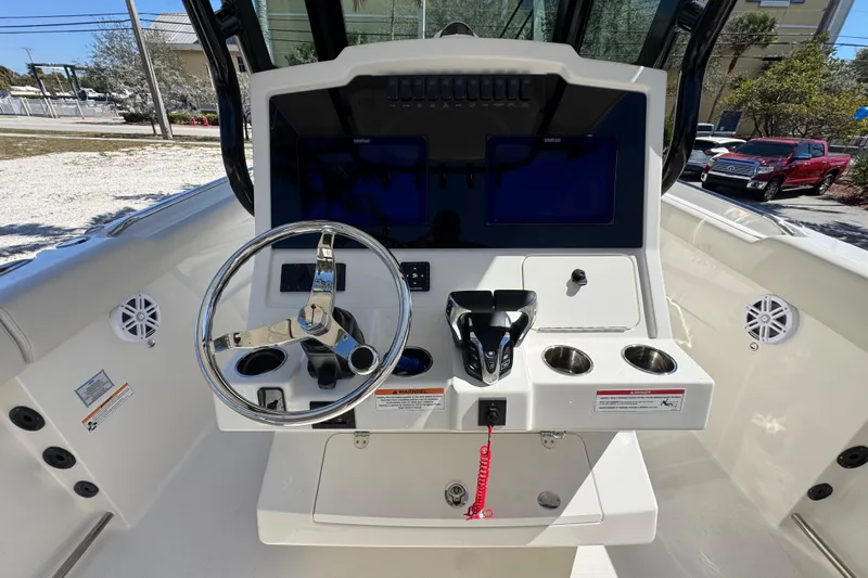  Yacht Photos Pics 2026 Sailfish 272 CC boat dashboard with steering wheel and control panel.