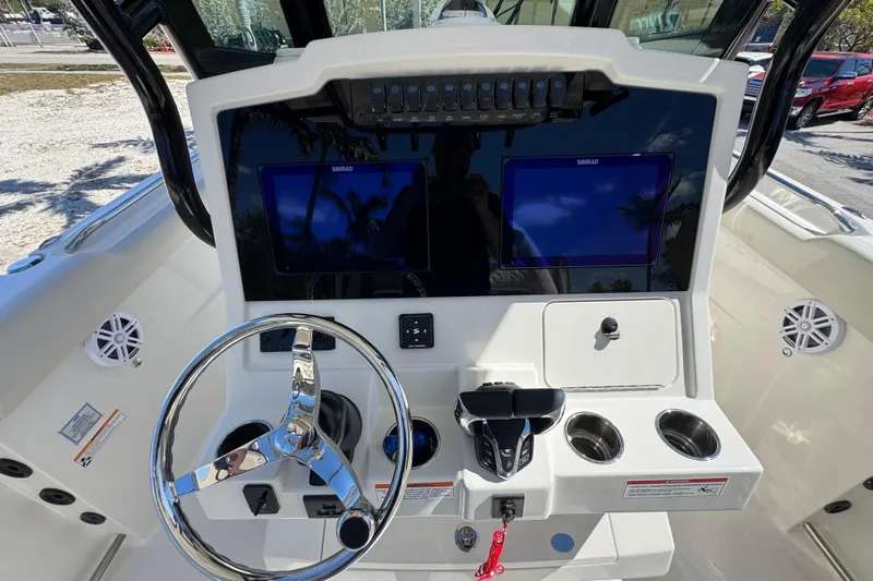  Yacht Photos Pics 2026 Sailfish 272 CC boat dashboard with dual Simrad displays and chrome steering wheel.