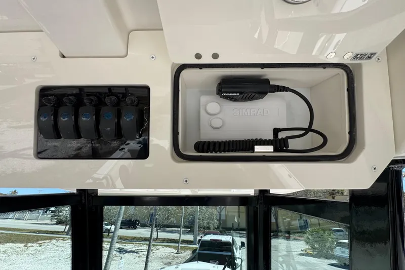  Yacht Photos Pics 2026 Sailfish 272 CC boat dashboard with Simrad radio and control switches.